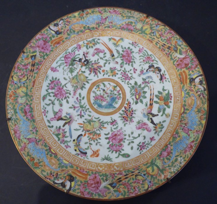 A 19th century Chinese Canton porcelain charger; hand decorated in the famille rose palette; the