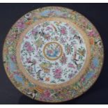 A 19th century Chinese Canton porcelain charger; hand decorated in the famille rose palette; the