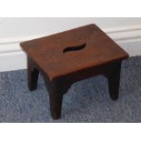 An early 19th century mahogany stool of small proportions; raised on square tapering legs mounded on