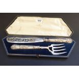 An ornate pair of 19th century hallmarked fish servers comprising slice and fork; each with double-