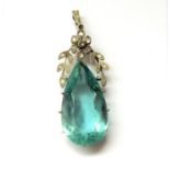 An Edwardian aquamarine and diamond-set pendant; the pendeloque faceted aquamarine to the floral and