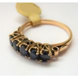 A 18-carat gold ring set with five sapphires; ring size P (total weight approx. 3.29g) (The cost