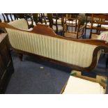 A late Regency / early Victorian rosewood-framed upholstered sofa; scrolling ends carved with