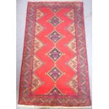 A 20th century Hamadan rug with red ground (226cm x 128cm)