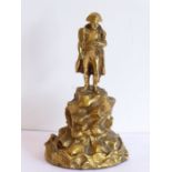 A heavy gilt-bronze model of Napoleon standing upon elevated jagged rockwork, probably late 19th/