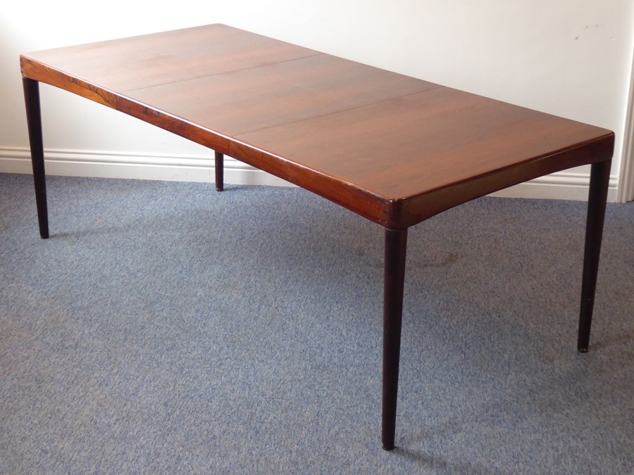 A 20th century extending rosewood dining table by 'Bramin' (Denmark); with central extension leaf