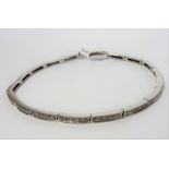 An 18-carat gold multi-diamond-set tennis bracelet (length 18.5cm; approx. weight 9.82g) (The cost