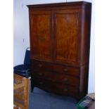 A late 18th century George III period mahogany linen press; the cornice above two panelled doors