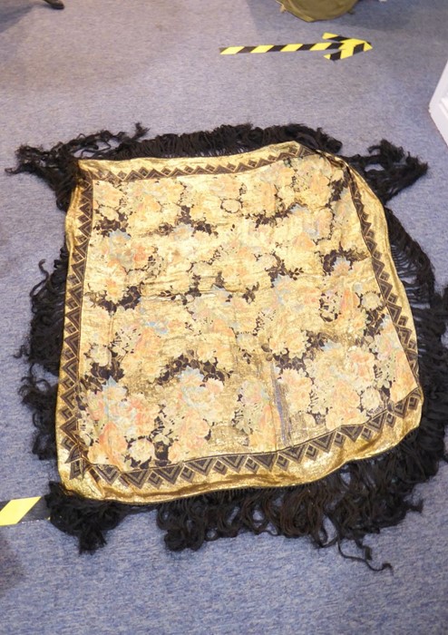 An early 20th century shawl; fine floral decoration in gold-coloured thread and with long black