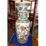 A large mid-19th century Chinese porcelain vase; the flaring rim above a waisted neck decorated in