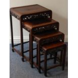 A nest of four early 20th century Chinese carved hardwood occasional tables, the pierced friezes