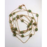 An 18-carat yellow-gold, emerald bead and seed pearl long chain necklace, the trace link chain