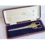 A cased pair of Walker & Hall Ltd (Sheffield) silver-gilt handled scissors with stainless-steel