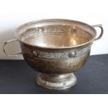A hallmarked silver two-handled pedestal bowl decorated with a Celtic-style band below the averted
