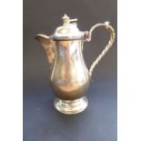 A heavy hallmarked silver baluster-shaped hot-water jug with hinged lid, maker's mark 'S & Co',