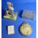 An antique Asian silver spice box, an Asian silver guardian lion, a mother of pearl brooch and a