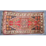 A small south-west Persian mat (89cm x 47.5cm)