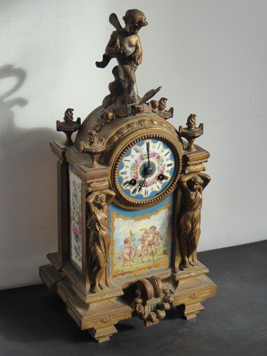 A 19th century gilt-metal eight-day mantle clock with Sèvres-style porcelain panels decorated with