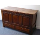 A mid-18th century oak mule chest; the two-plank, cleated top studded with the initials I T and