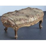 A 19th century carved kidney-shaped gilt-wood stool in Louis XV-style; original upholstery above