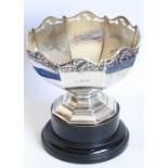 A hallmarked silver octagonal pedestal bowl; the pierced border cast with flower heads and leaves,