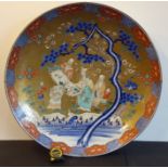An extremely large 19th century Japanese porcelain charger; centrally decorated against a gilt