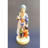 A late 19th/early 20th century Japanese porcelain figure; the blue-robed female with head covering