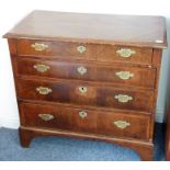 An early 18th century walnut chest; the quarter veneered chevron banded top with thumbnail