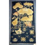 A blue Tibetan Baotou Suiyuan rug decorated with two Mandarin ducks on a lotus pond, circa 1920 (