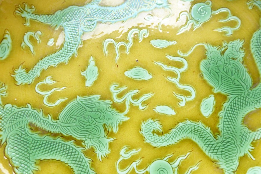 A Chinese porcelain scrafitto dish; three green dragons chasing pearls amongst clouds against an - Image 4 of 9