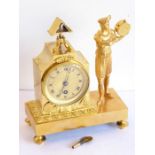 A 19th century French Empire style gilt-metal eight-day figural mantel clock; the textured gold-
