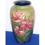 A large Moorcroft pottery vase decorated with red lilies;  painted and impressed marks to