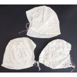 Three circa 1920s lawn embroidered baby's bonnets; ivory cotton lawn with broderie anglaise