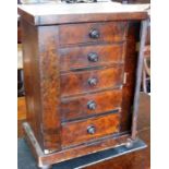 A 19th century miniature walnut-veneered Wellington chest of five graduated drawers; raised on