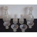 A pair of 19th century mallet-shaped cut-glass decanters with mushroom stoppers and annulated necks;