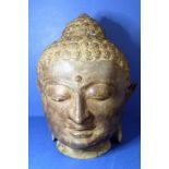 An antique bronze Buddha head (33cm high)