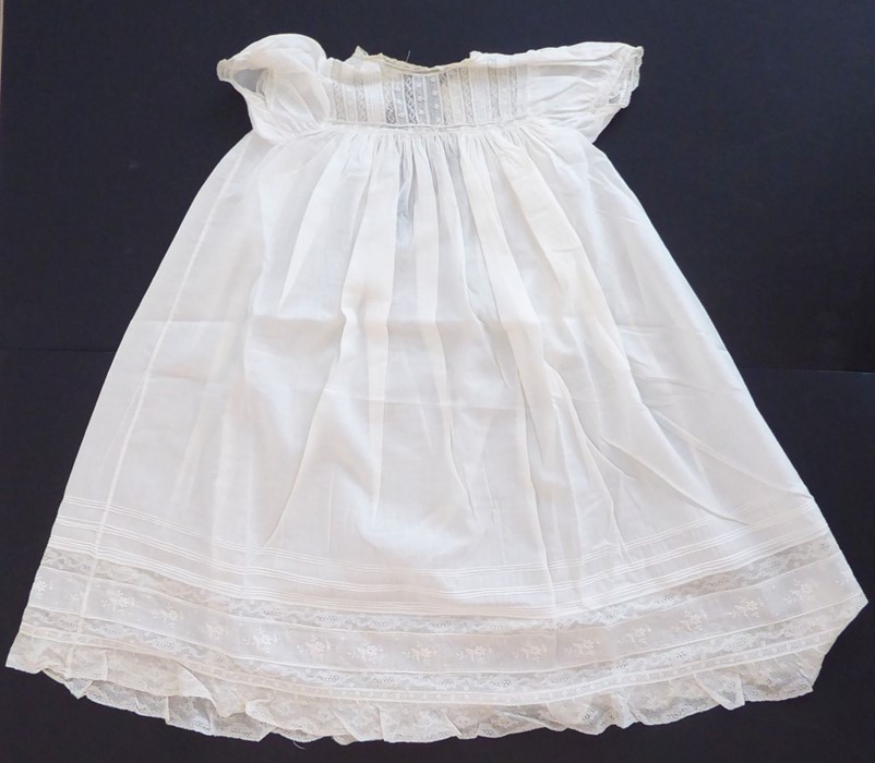 A 1930s Happy Days baby's cotton nightgown; ivory cotton lawn with white work details and applied
