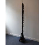 An early 20th century Chinese hardwood lamp standard carved in high relief with prunus blossom