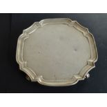 A heavy hallmarked silver salver (dents), maker's mark of Goldsmiths & Silversmiths Company Ltd,