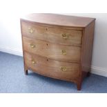 An early 19th bow-fronted mahogany chest (faded); the reeded edge top above three full-width