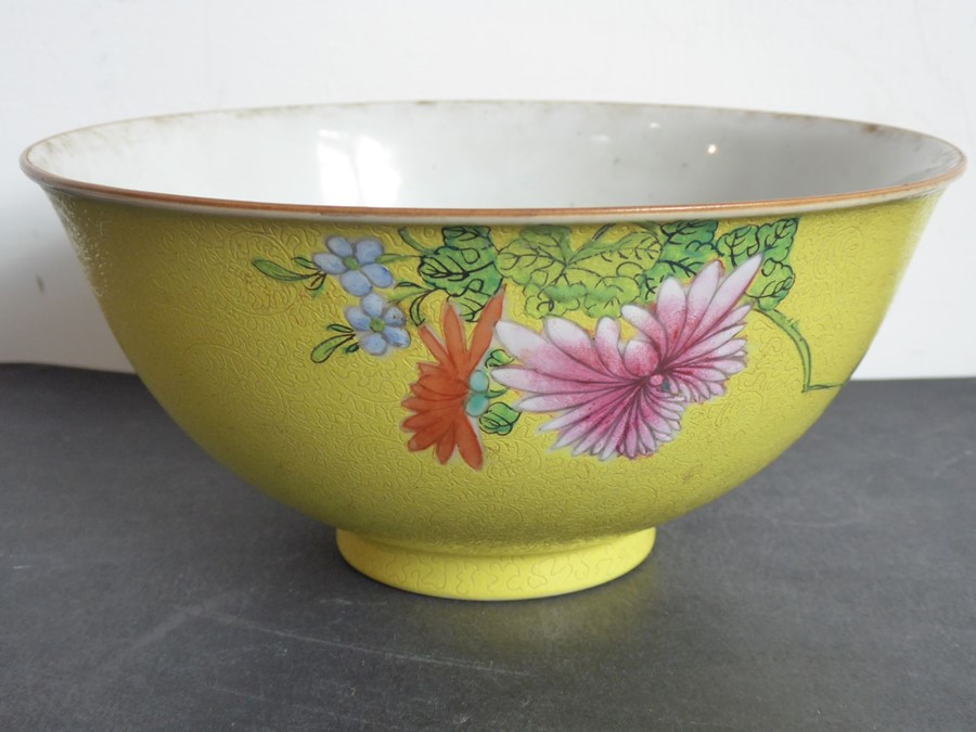 A 19th century Chinese porcelain yellow-ground scrafitto bowl; the feathery scroll incised ground