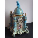 A large 19th century continental porcelain eight-day mantle clock of architectural form; the domed