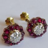 A pair of yellow-metal mounted earrings, each earring centrally set with a fine old-cut diamond