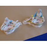 A pair of 19th century hand-decorated continental porcelain bon-bon dishes modelled as recumbent