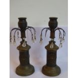 A pair of French Empire bronze candlesticks with cut-glass lustres (minus two lustres) each on