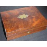 A 19th century flame mahogany-veneered velvet-lined box; the ornate inset brass cartouche engraved