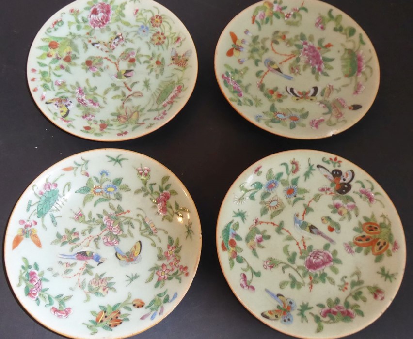 Four late 19th century Chinese celadon glazed circular dishes hand-decorated enamels with flowers