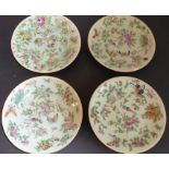 Four late 19th century Chinese celadon glazed circular dishes hand-decorated enamels with flowers