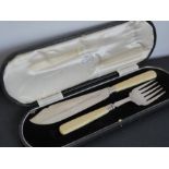 A cased pair of hallmarked silver fish servers comprising slice and fork (cased), marked for the