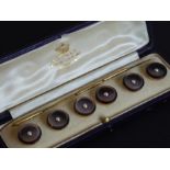 A set of six yellow-gold (marked 15 C) and mother of pearl buttons, each centred with a small pearl,